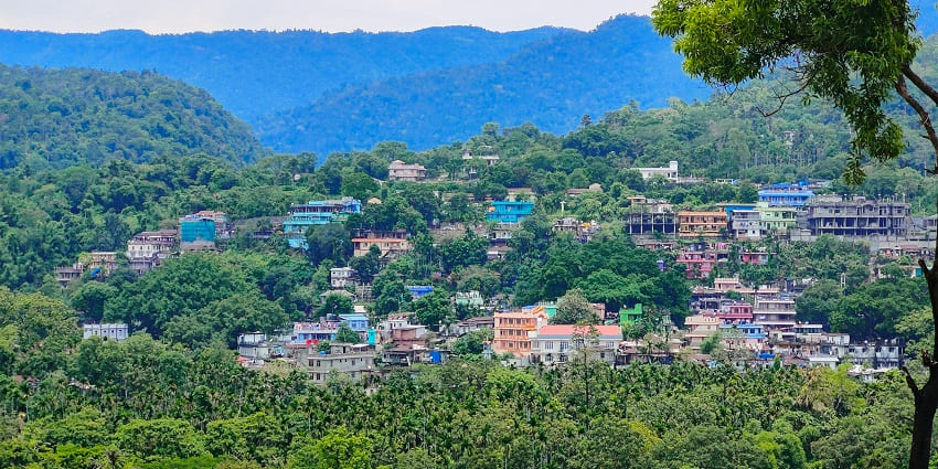 An image of Teesta Bazaar showing the beauty of lush green nature and colourful town.