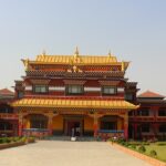 large temple in Canada with intricate architectural details surrounded by trees.