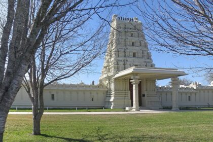 An image of a temple in Texas centre with tall buildings, and wide streets in Plano, Texas