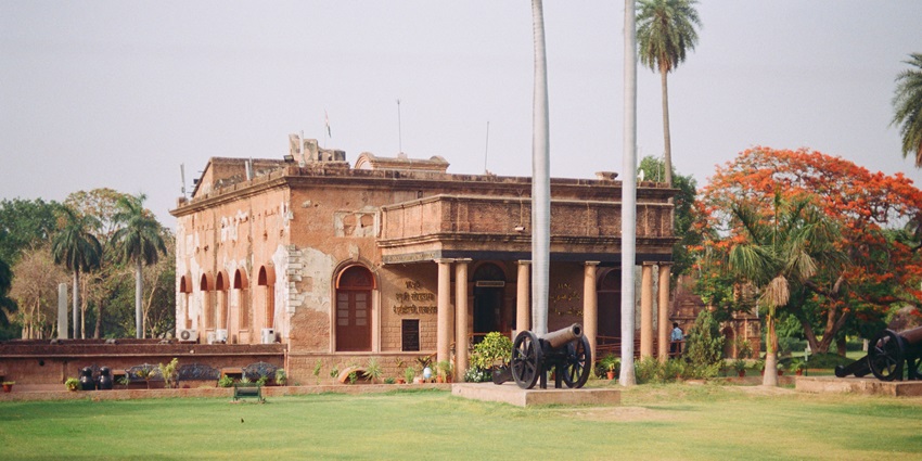 An image of the historic ruins of the British Residency in Lucknow, surrounded by lush greenery.