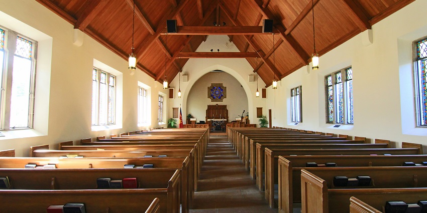The Cathedral Basilica with rows of seats, statue of Christ and painted wall interiors