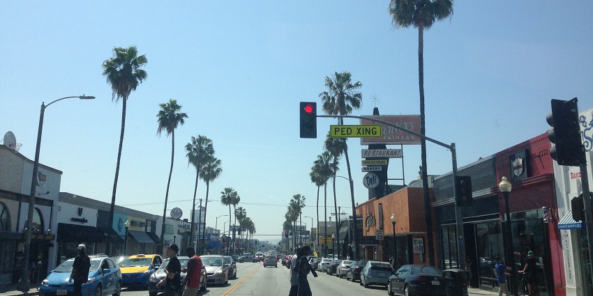 A vibrant view of a road with vehicles, a popular place near the Los Angeles County Museum of Art