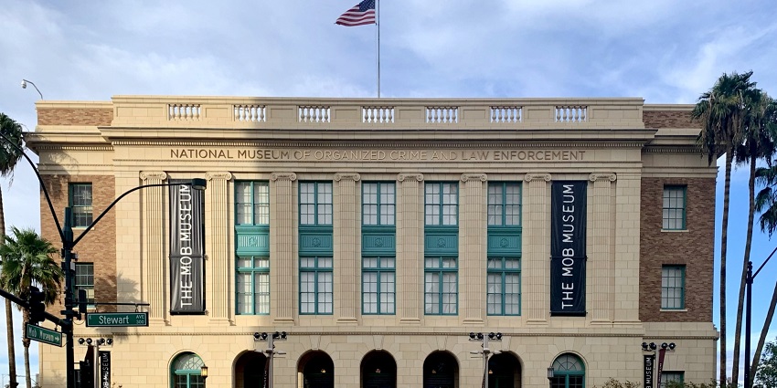 Outside the mob museum with the American flag on top of the building and people visiting
