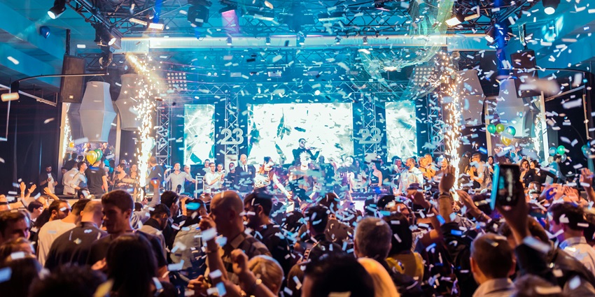 A picture of the Myx in Kolkata including people dancing with others on the DJ floor
