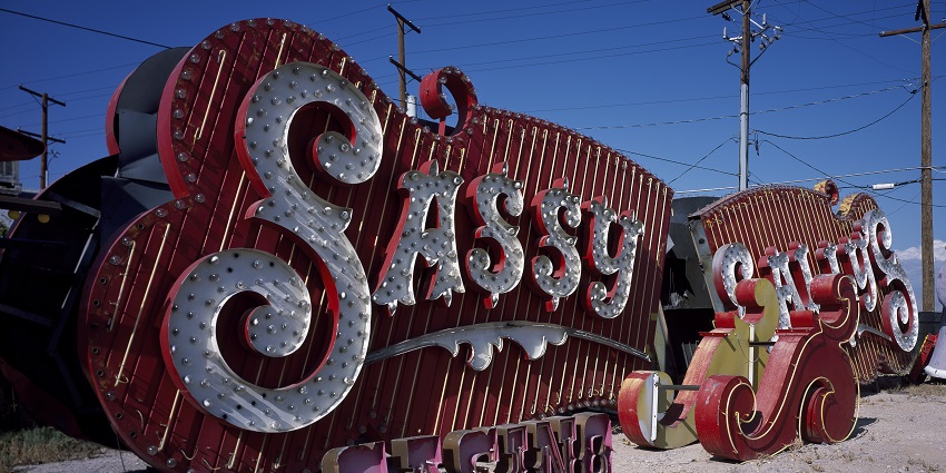 Rusted Las Vegas signboard well lit up with neon lights and designs at neon boneyard
