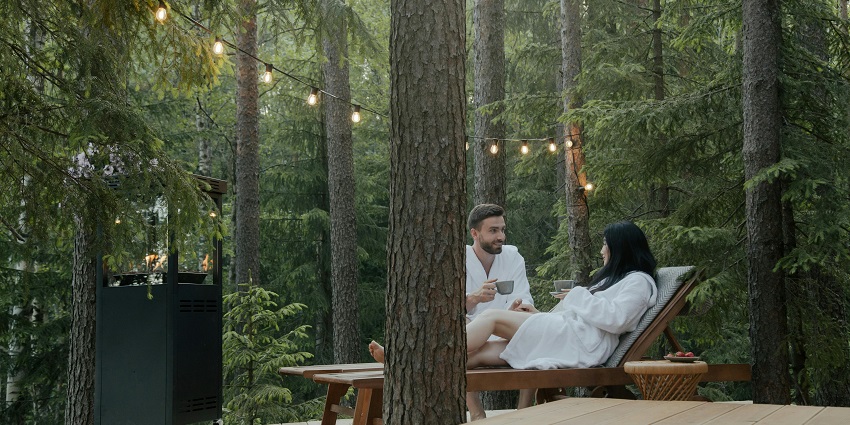Couples sitting and facing each other, surrounded by trees and lights hanging from trees
Viewers of this file can see comments and suggestions