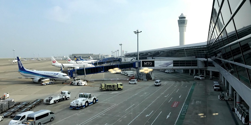 Interior of Thessaloniki airport with Makedonia signage and people carrying luggage