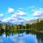 The serene Bow River with snow-covered mountains in the background in Banff, Alberta, Canada.