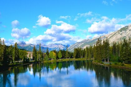 The serene Bow River with snow-covered mountains in the background in Banff, Alberta, Canada.