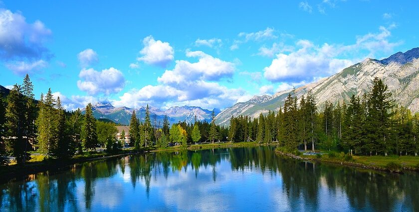 The serene Bow River with snow-covered mountains in the background in Banff, Alberta, Canada.