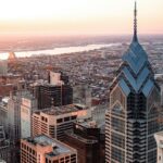 A view of city of Philadelphia from above the Delaware River and bridge during the sunrise.