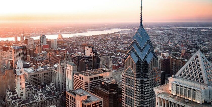 A view of city of Philadelphia from above the Delaware River and bridge during the sunrise.