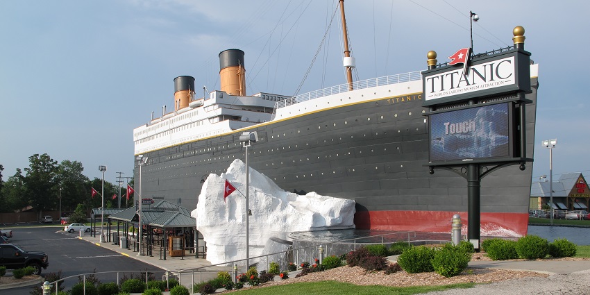 An image of Titanic Museum in Branson, shaped like the ship’s bow, with flags and lifeboats displayed.