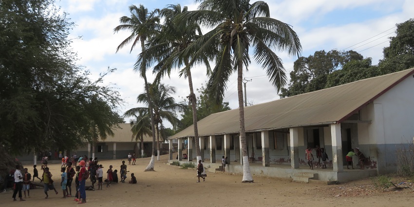 Locals having a good time at a ground with huts in Toliara