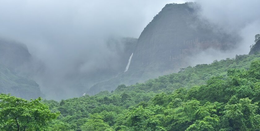 A picture of Bhandardara Trekking scenic view of Ratangad Lake surrounded by lush hills.