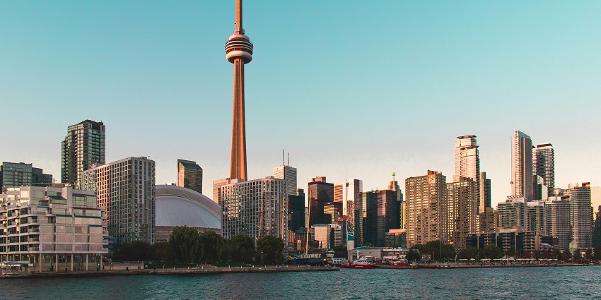 The CN Tower under a blue cloud-filled sky has been clicked from a lower downside.