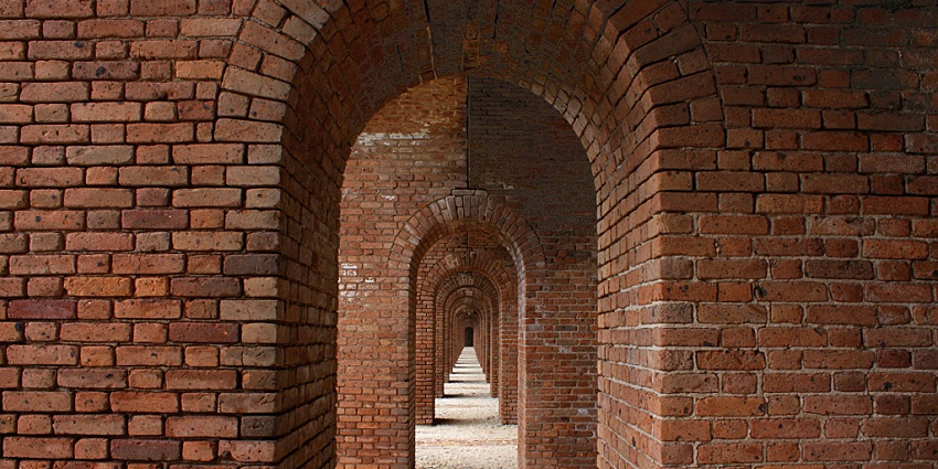 A corridor through a red brick structure in Fort Jefferson, Dry Tortugas National Park, Florida