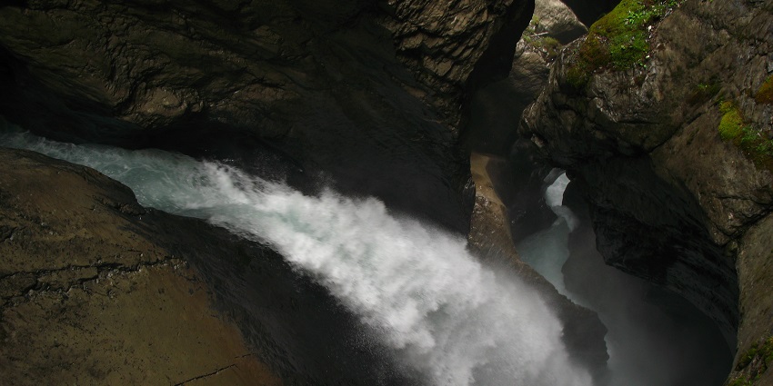 Powerful glacier-fed waterfalls flowing within mountain caves and tunnels