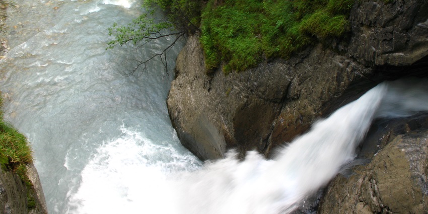 Impressive glacial waterfall within mountain caves, accessible by tunnels.