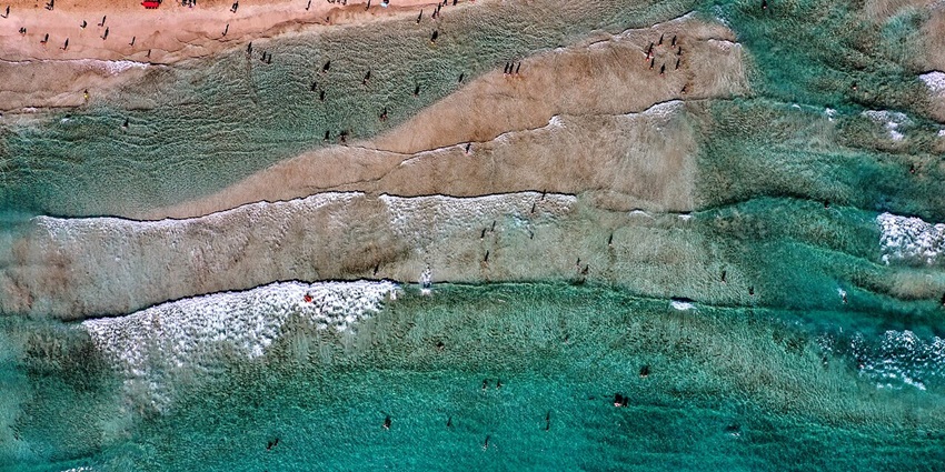 Historic beach offering ancient ruins, clear waters, and scenic views.