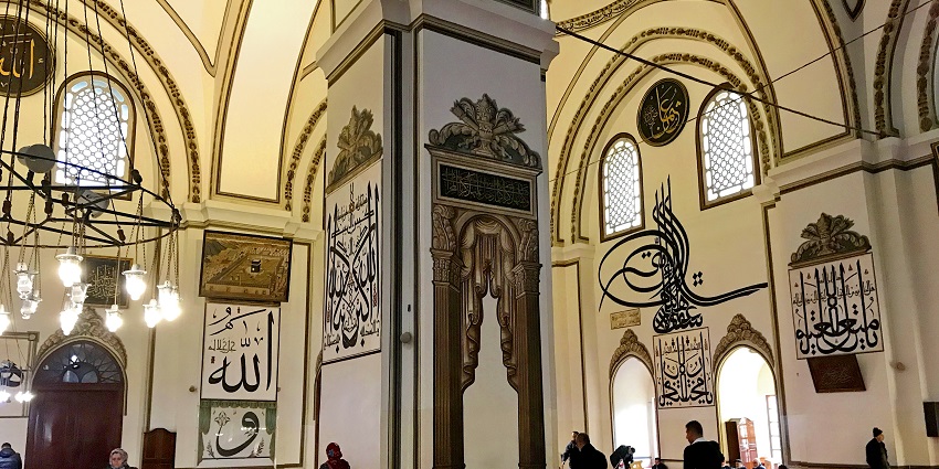 Grand mosque with elegant calligraphy and serene prayer spaces.
