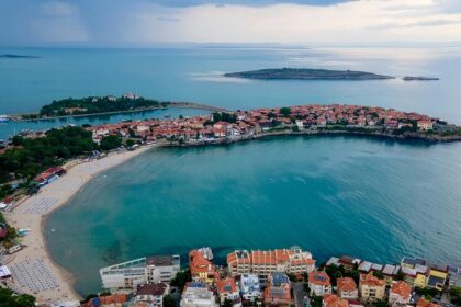 Seaside town in Bulgaria with small islands in the distance and small buildings