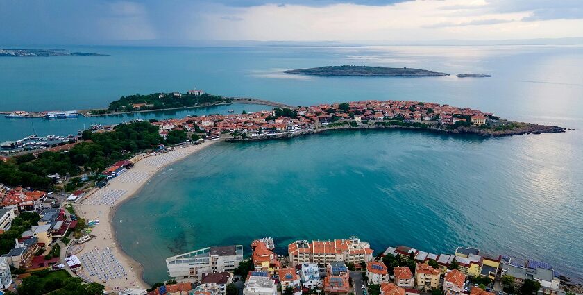 Seaside town in Bulgaria with small islands in the distance and small buildings