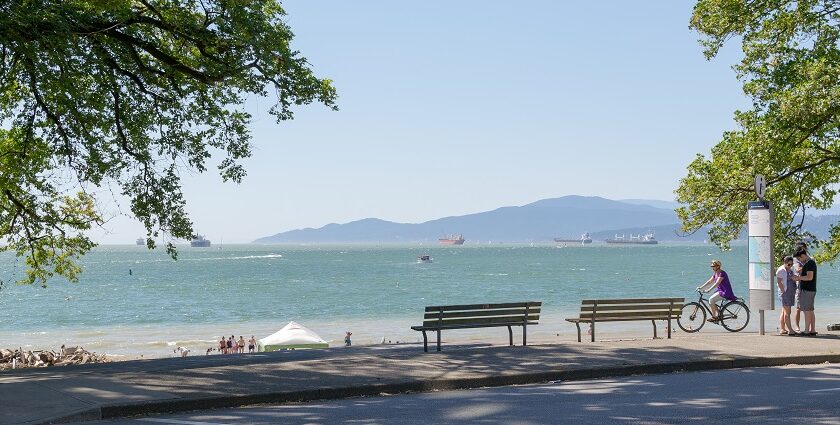 A scenic view of English Bay in Vancouver, featuring calm waters and a vibrant coastline.