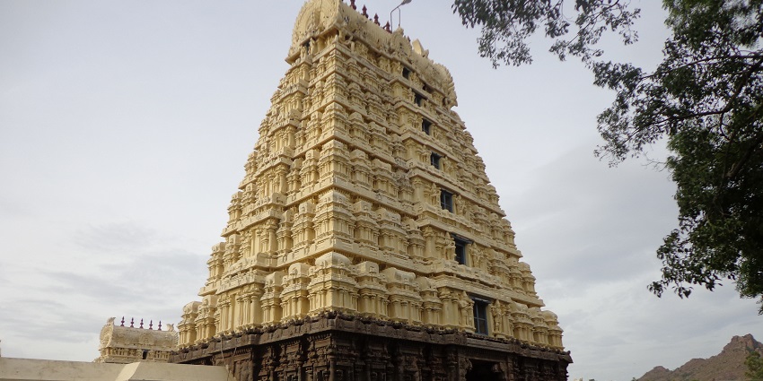 A historic temple with intricate stone carvings and towering gopurams inside Vellore Fort.
