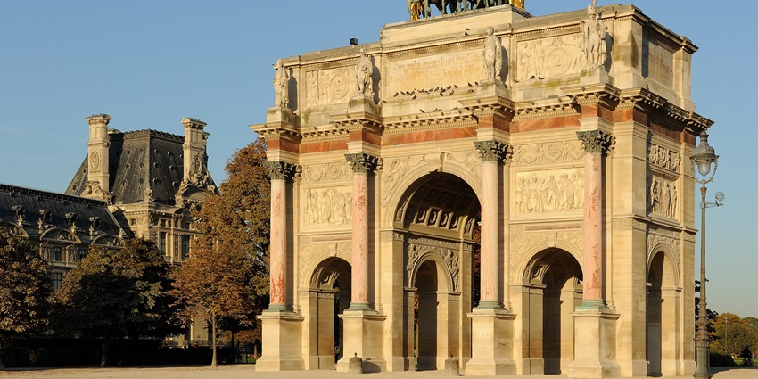 A picture of the centre of the famous Arc de Triomphe with intricate carvings on its walls
