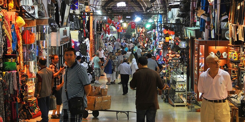 Bustling market with shops offering jewellery, textiles, and souvenirs.