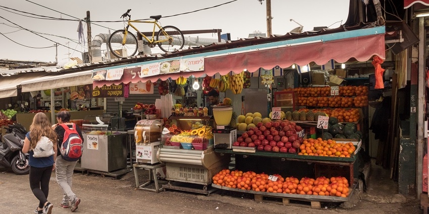 A view of Carmel Market which is a lively market with fresh produce, spices, and local goods.