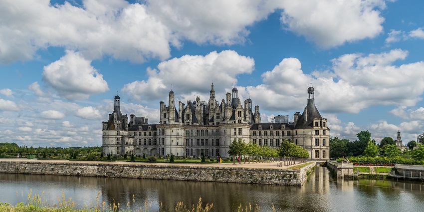 Majestic Renaissance castle surrounded by scenic forests and grounds