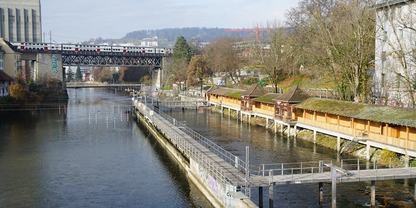 Riverside swimming area popular for sunbathing and relaxation