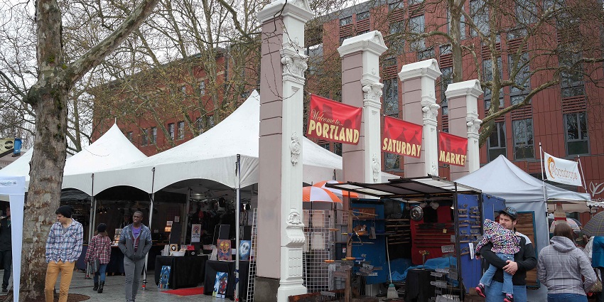 Visitors buy different things at the shops in Portland Saturday Market, Oregon, USA.