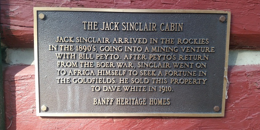 A board shows information about Jack Sinclair Cabin in Whyte Museum, Banff, Alberta.