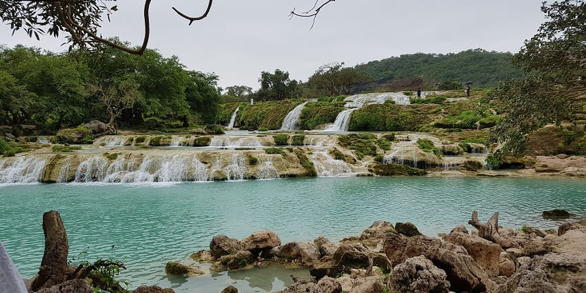 Breathtaking valley with waterfalls, lakes, and lush green landscapes