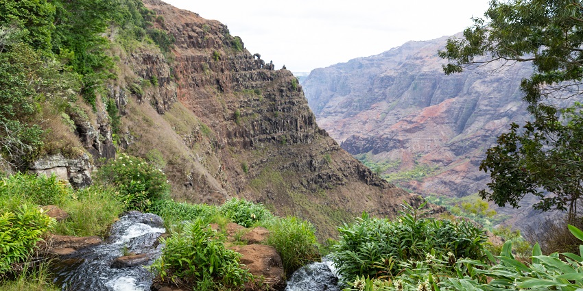 An image showing a view of the Waipo’o Falls located in Waimea Canyon, Kauai.