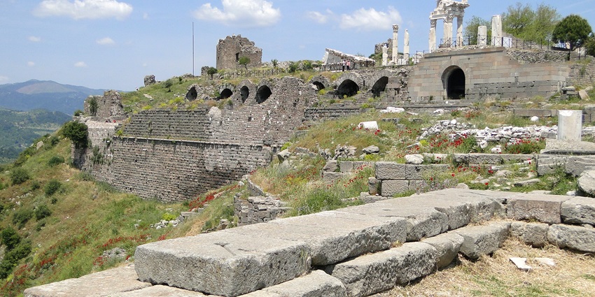 Ruins of the Acropolis at Pergamon, Turkey, showing ancient stone structures on hillside.