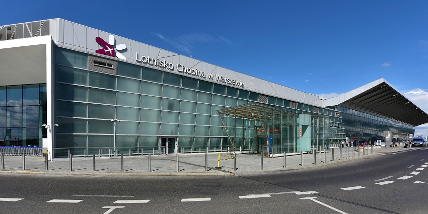 Warsaw Chopin Airport with modern architecture, an entrance gate and a car-parked