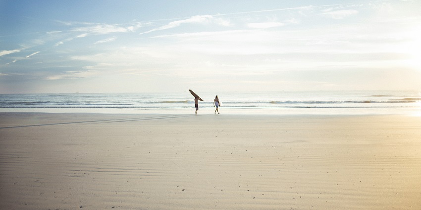 A Wasaga Beach in Ontario at sunset with its sandy shores and crystal-clear water.