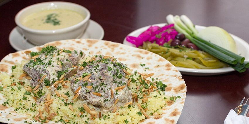 A view of traditional Jordanian cuisine with stunning archaeological site views.