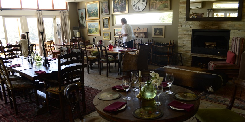 A waiter serving food at an exquisite restaurant near Boulders Beach