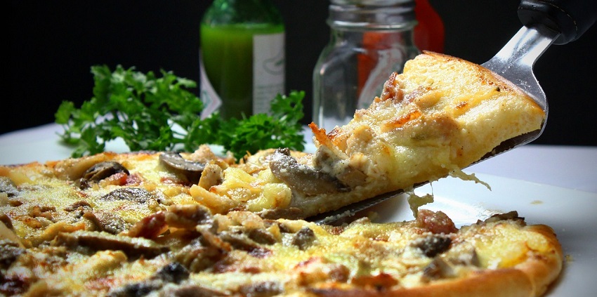 A mouthwatering pizza slice ready to be enjoyed in restaurants near Arches National Park