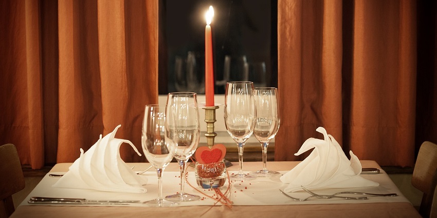 Elegant dinner table setup featuring romantic decorations and candlelight ambience