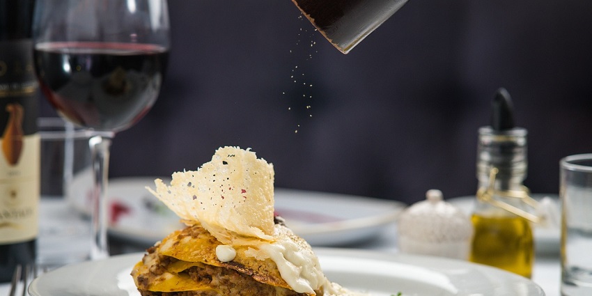 A delicious lasagna pasta meal with layers of cheese and tomato sauce on a plate.