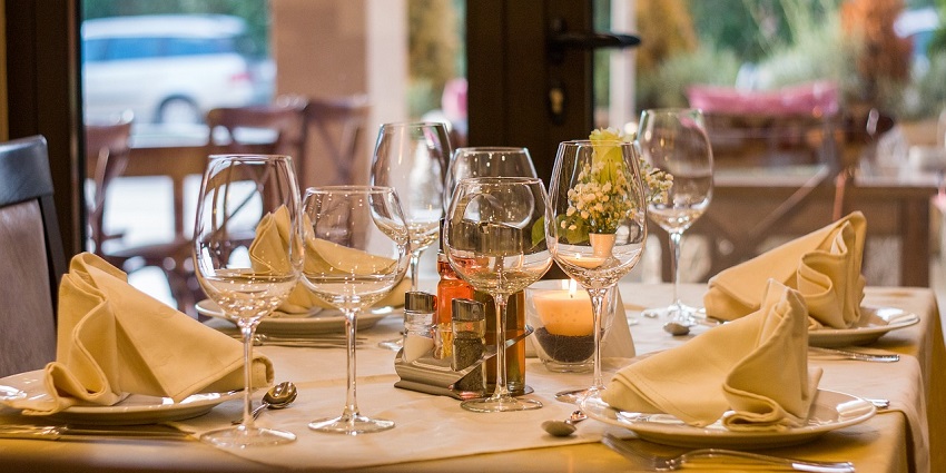 Sophisticated restaurant table setting with elegant tableware and folded napkins