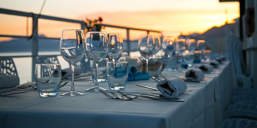A table setting with glassware, cutlery, and plates arranged for a fine dining experience.