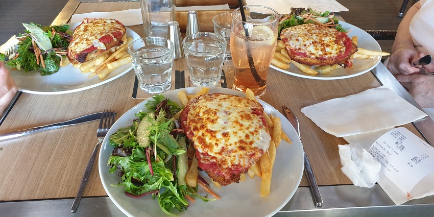 Image of a restaurant food served on a dining table with different types of delectable food .