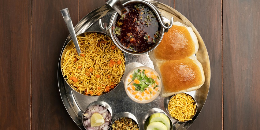 Image of a plate offering vibrant flavours of Maharashtra during your visit